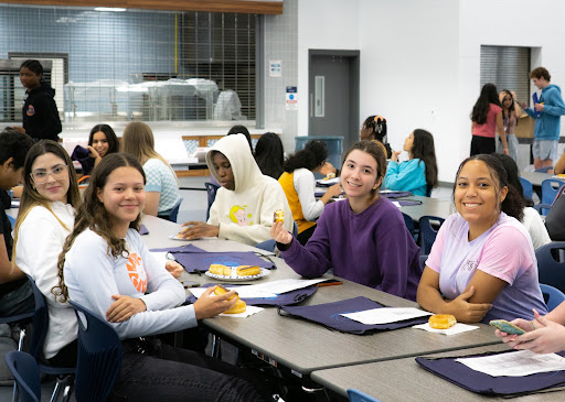 Danes, donuts, and delight. New students share breakfast in the cafeteria.