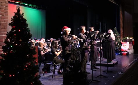 Sam Mesi, senior, Nathan Pak, sophomore, and Kai Burdick, junior, perform a solo during the song Buglers Holiday.