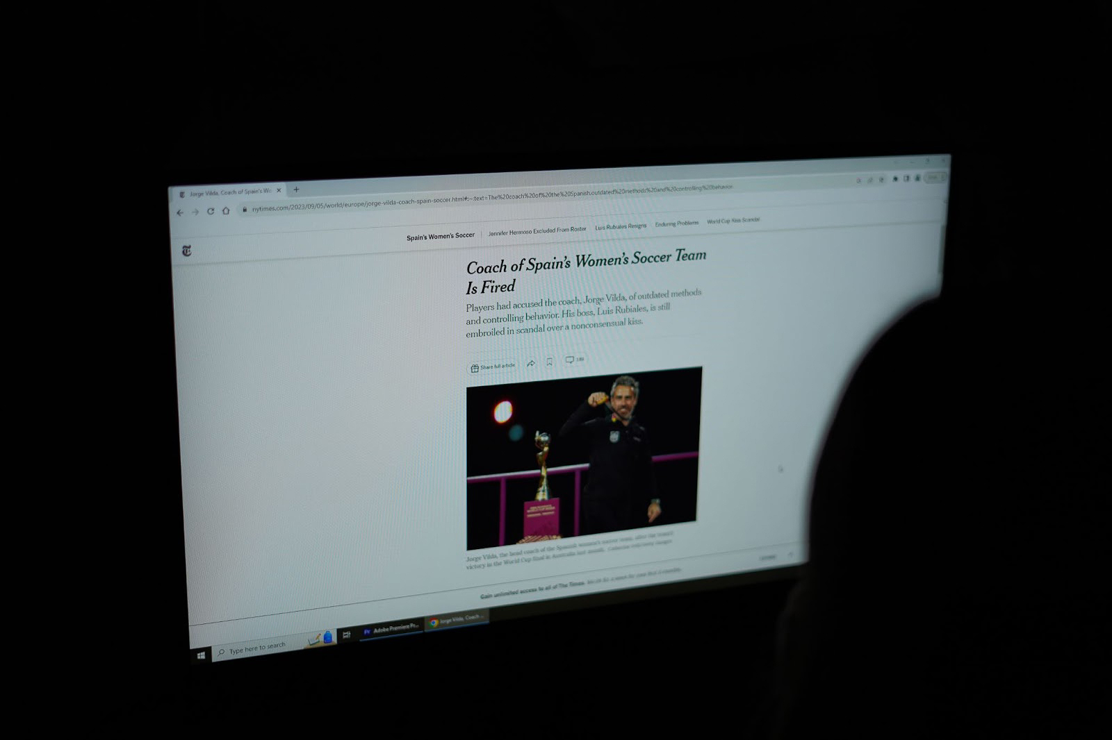 A student reads about the dismissal of the Spain Women Soccer Teams coach.